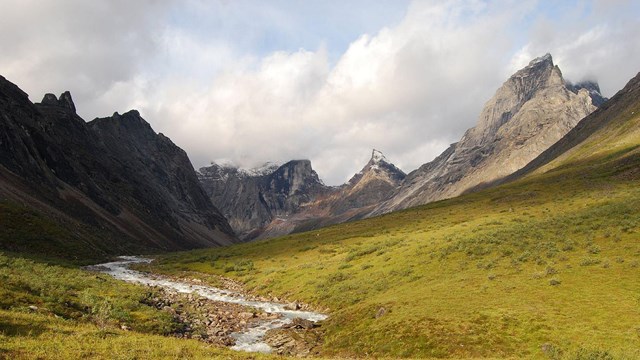 the Arrigetch Peaks in Gates of the Arctic National Park with a river in the foreground