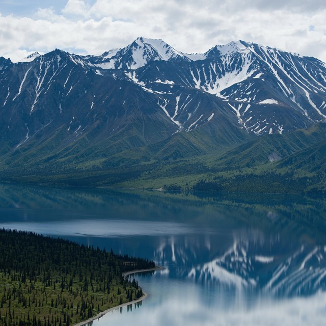 mountains in Lake Clark National Park reflected in calm waters