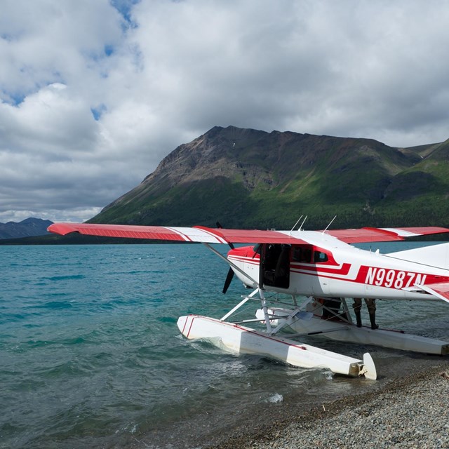 a plane docked on a beach in Lake Clark National Park