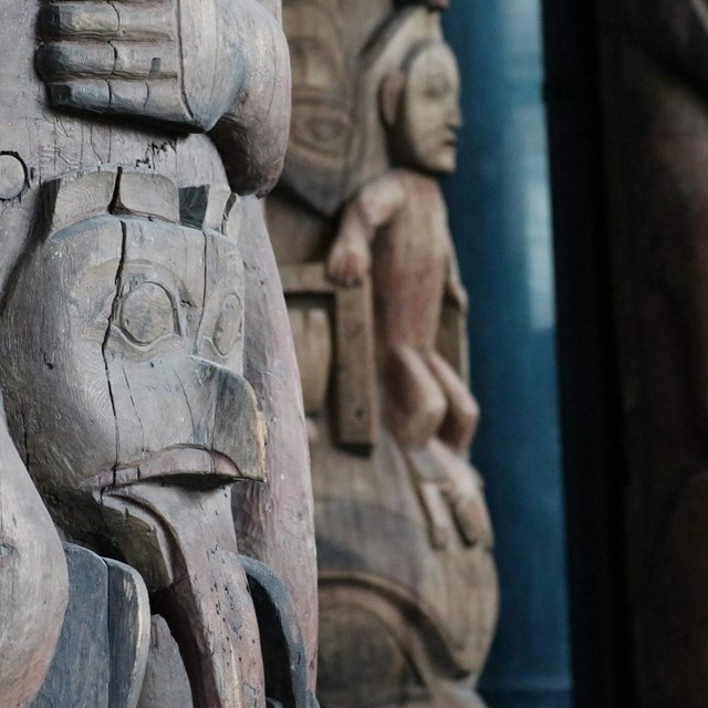 close up of the carvings of wooden totem poles