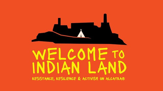 Black silhouette of an island with rectangular buildings and smokestacks sits against a red-orange b