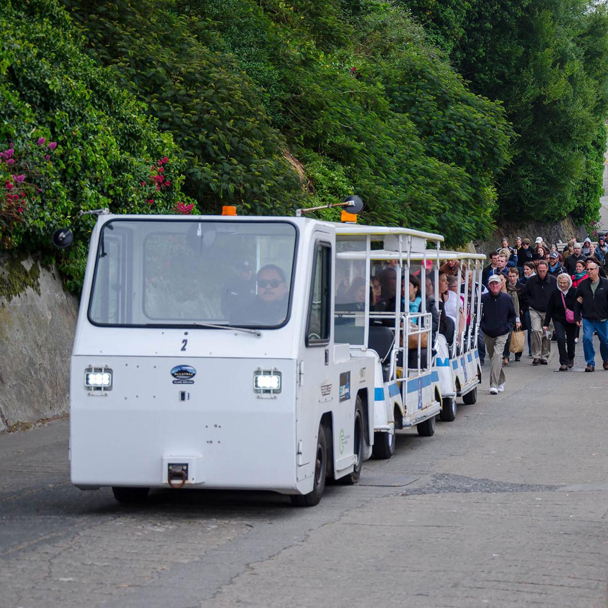 Tram carrying visitors up a steep slope. 