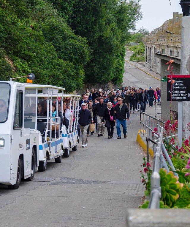 Tram carrying visitors up a steep slope. 