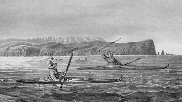 a historic illustration of two men in kayaks paddling in front of a coastal mountain range.`