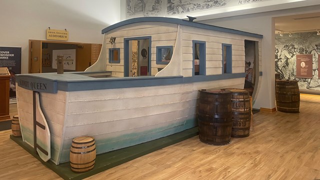 A canal boat model inside a building.