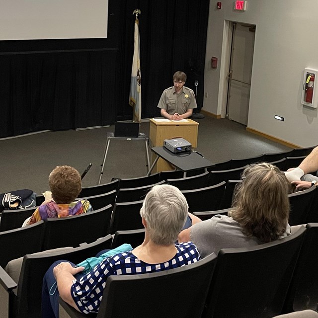 A park ranger presents a program in the auditorium. 