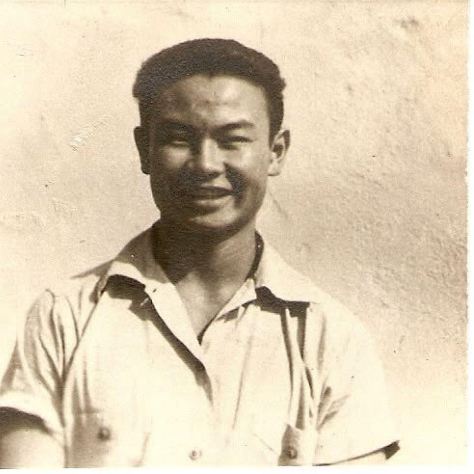 A young Japanese American man smiles at the camera