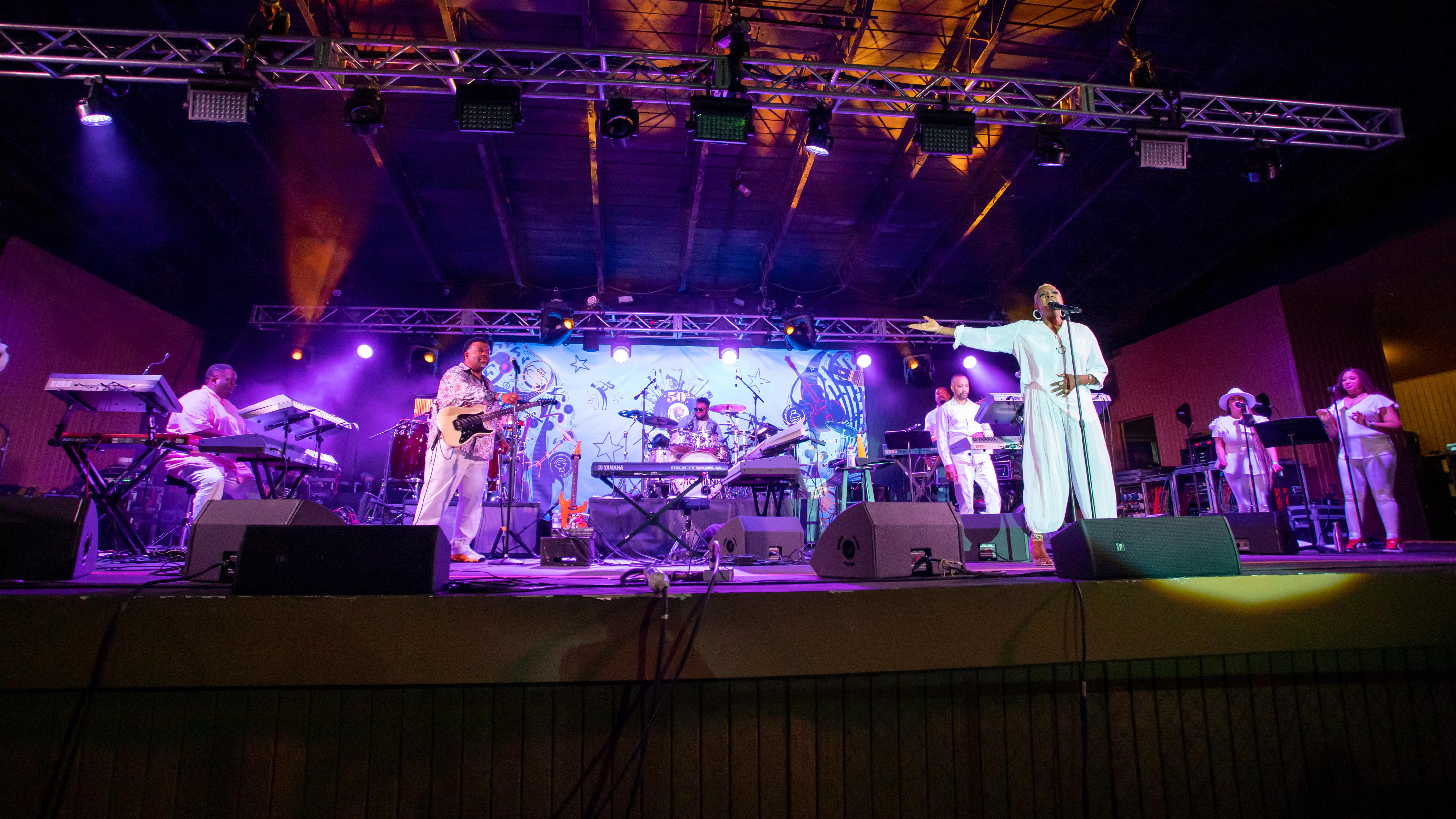 A group performs on an outdoor stage.