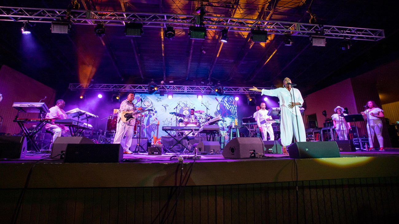 A group performs on an outdoor stage.