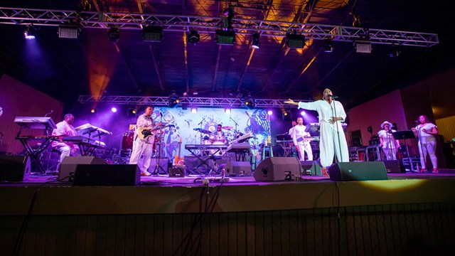 A group performs on an outdoor stage.