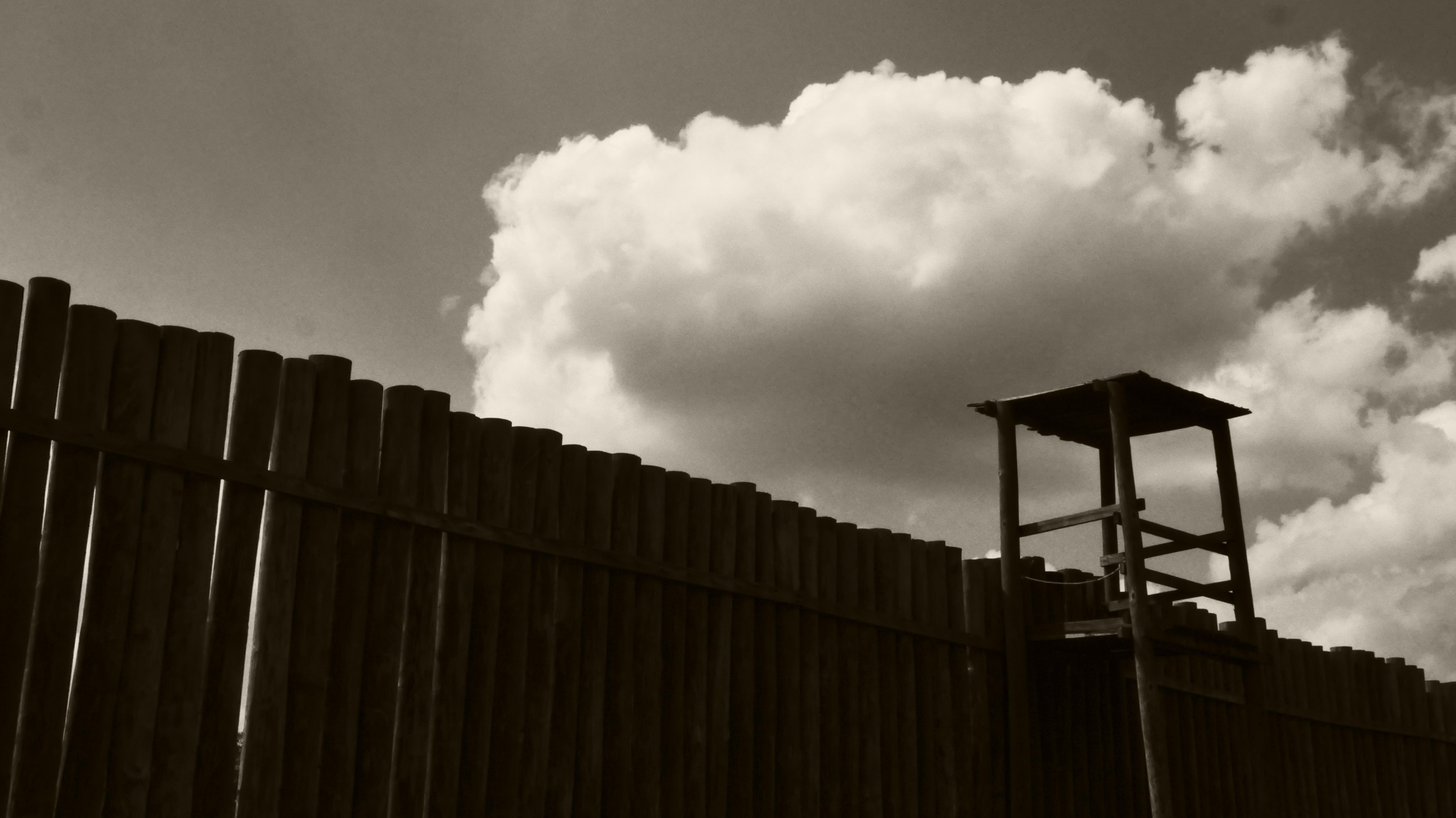 Large wooden wall with a lookout post in the far right.