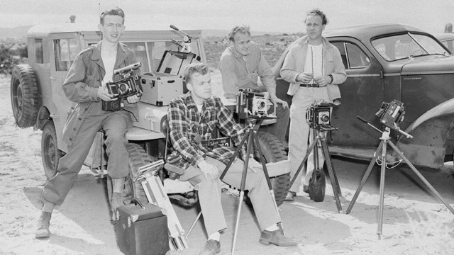 Photograph at the Windows Section is 4 men sitting on two vehicles with cameras on tripods.
