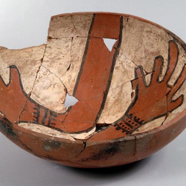 Bowl with red painted hands