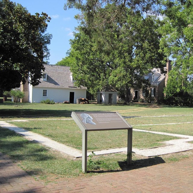 Outline of a building with an interpretive sign