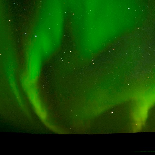 The northern lights dance across an Arctic sky.