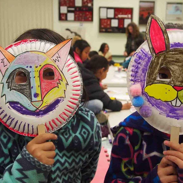 Two kids in animal masks they made.