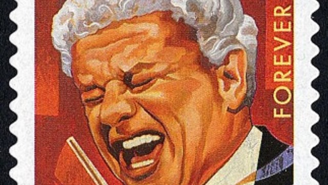 An upright rectangular stamp features artwork of Tito Puente, portraying a profile view of him.