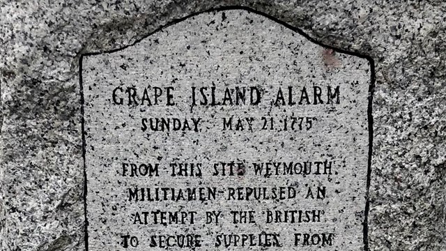 Granite stone with engraving of the "Grape Island Alarm"