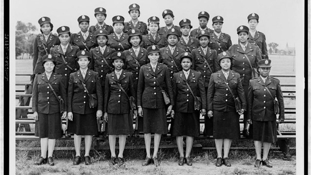 A group of African American women in military uniform standing in rows.