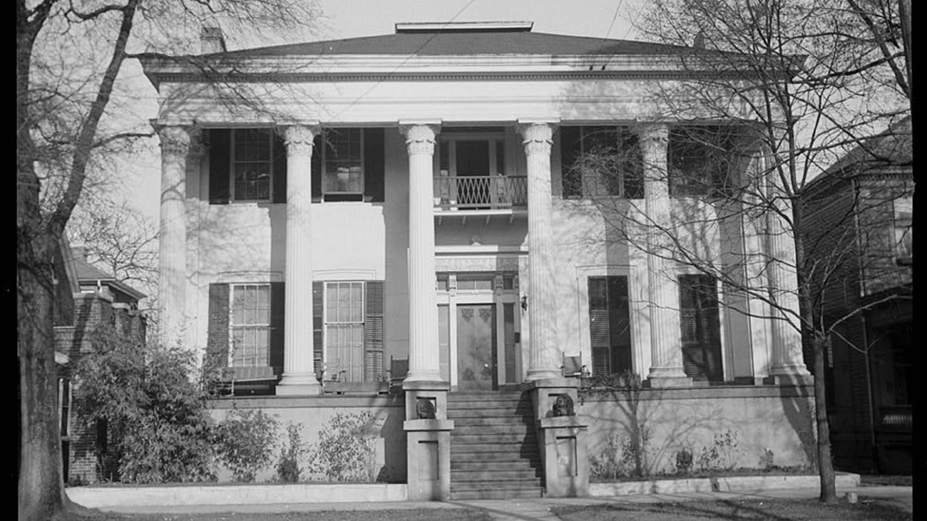 Exterior of large two-story house with Greek-Revival pillars. Library of Congress. 