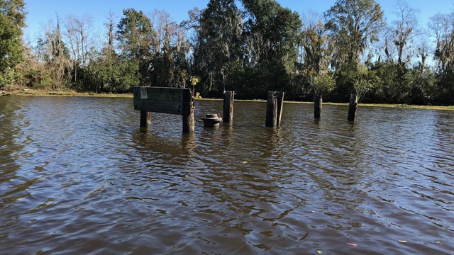 A well in the middle of a river, mostly covered with water.