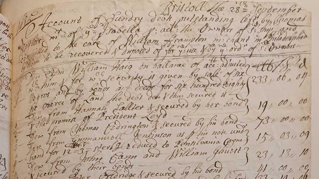 black ink handwriting on paper attached to a page of a book