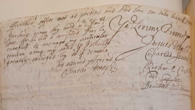 black ink handwriting on paper attached to a page of a book