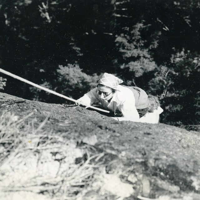 Woman climbing a rock