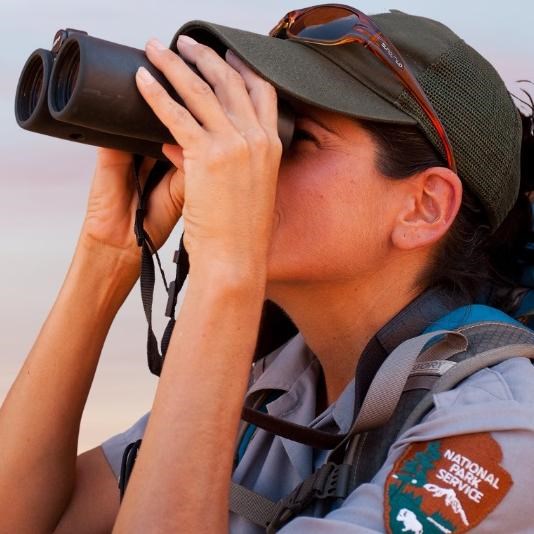 title image for Enjoy the View Like Us series featuring a woman using binoculars