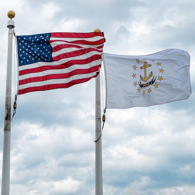 The flag of the city of Providence, the American flag, and the flag of Rhode Island