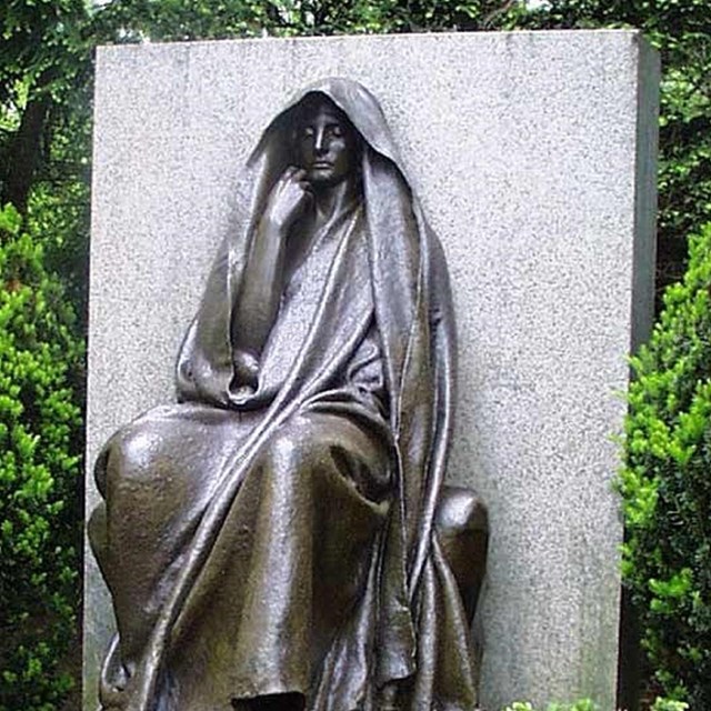 image of a statue of a woman in cloak. 