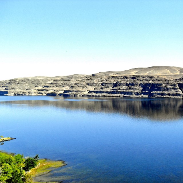 calm water with unique geologic features on the far bank
