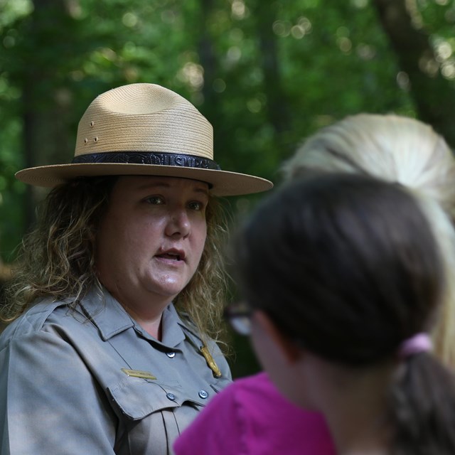 A woman in a NPS uniform and flat had talks to visitors.