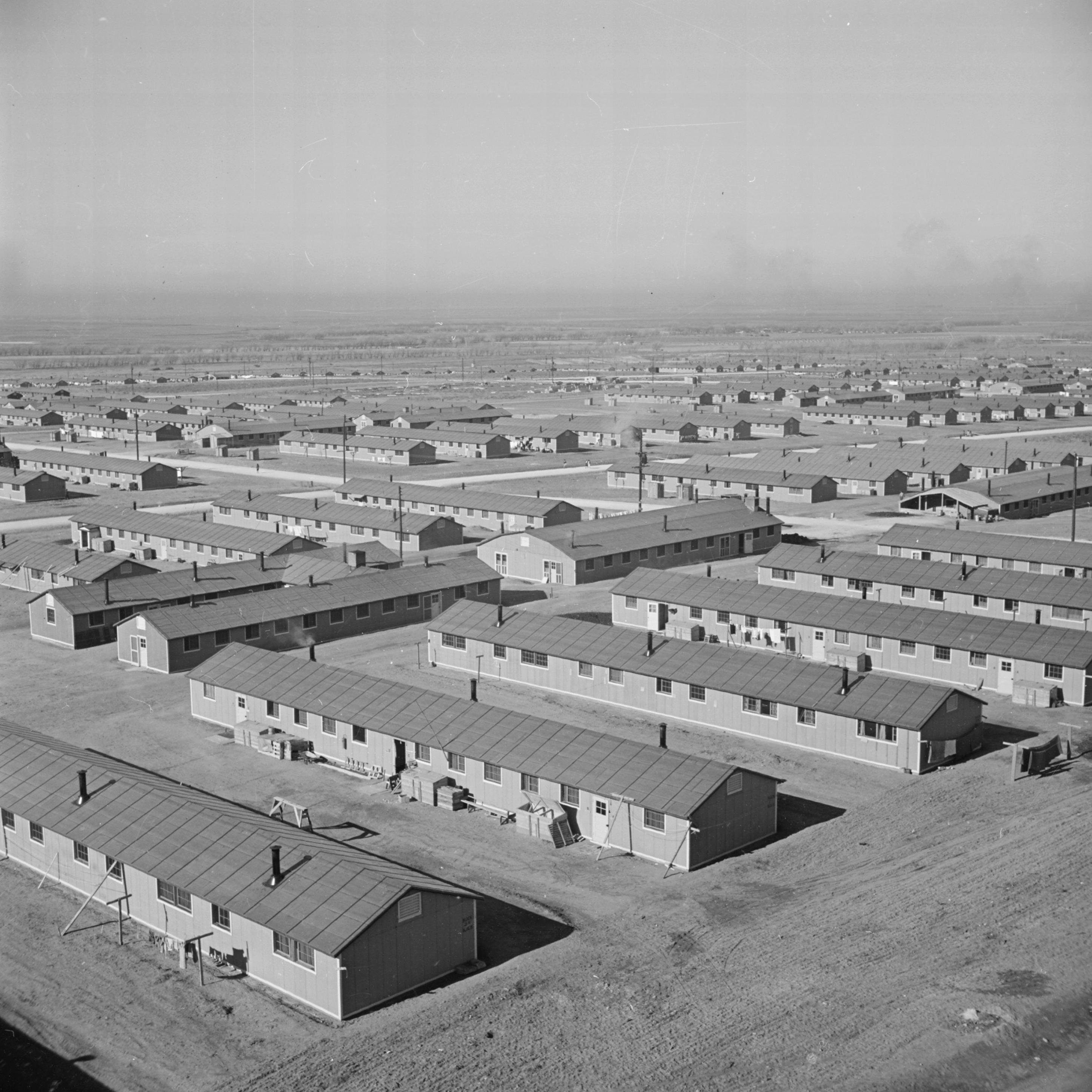Black and white aerial photograph of a series of barracks at Amache National Historic Site.