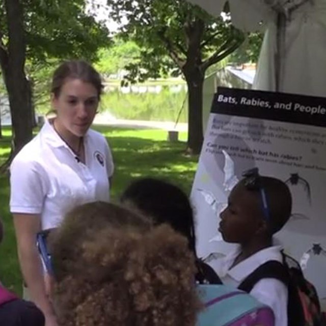 Michelle talking to a group of children on the National Mall about bats