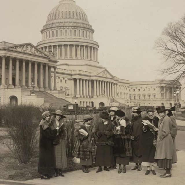 A group of women standing in front of the U.S. Capitol
