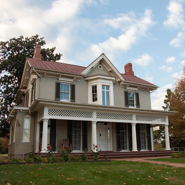 An elegant two-story house with a wide front porch