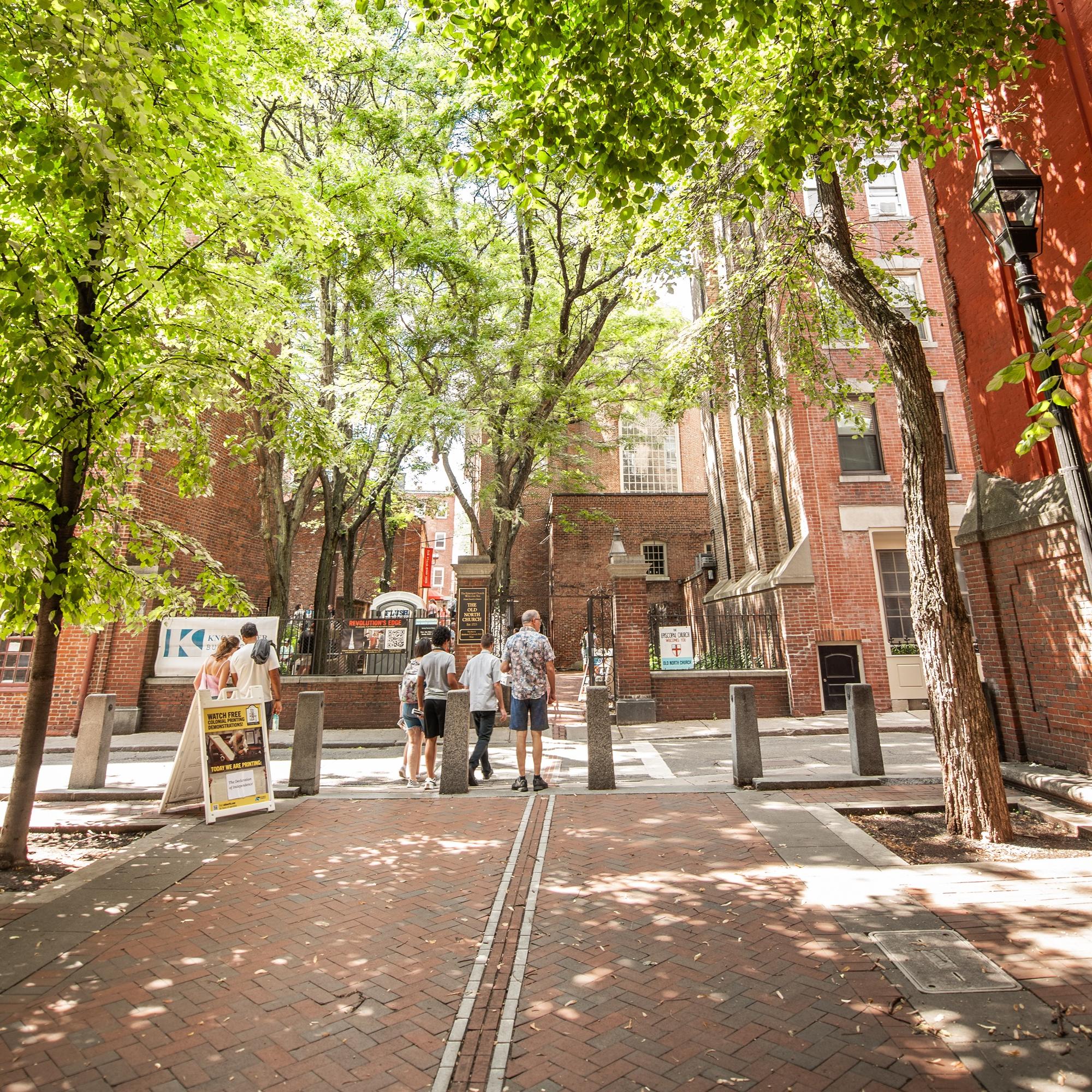 Photo of the red brick line of the freedom trail leadning to the Old North Church