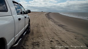 view looking north on Assateague beach from behind an over sand vehicle (OSV)