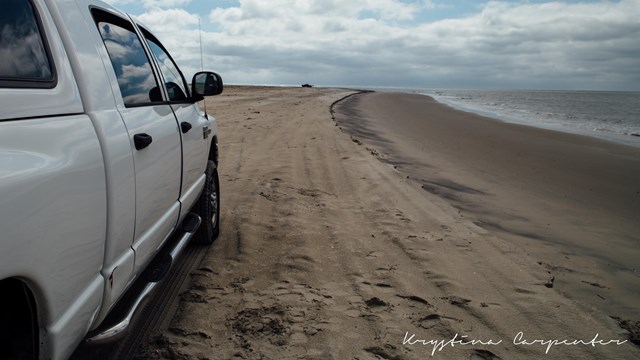 view looking north on Assateague beach from behind an over sand vehicle (OSV)