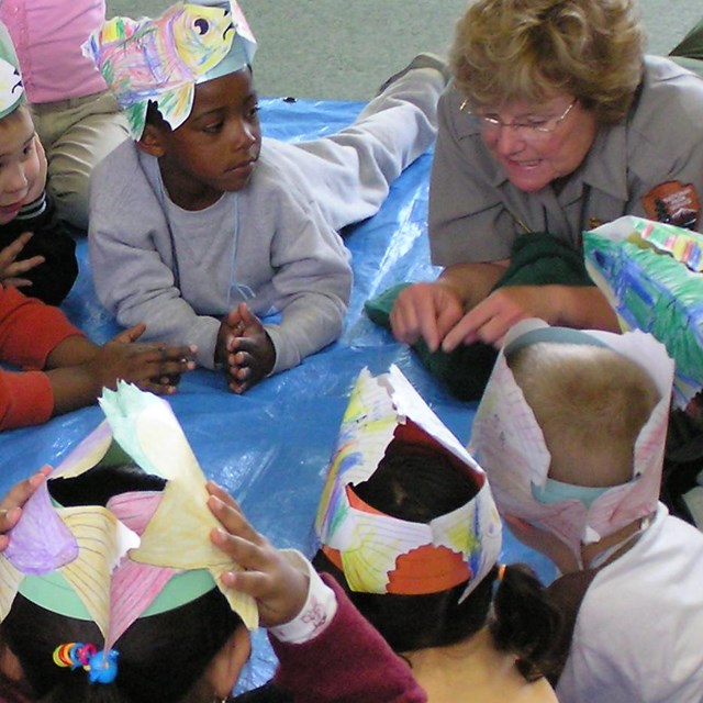 Ranger explains to students how fish survive in the great big ocean.