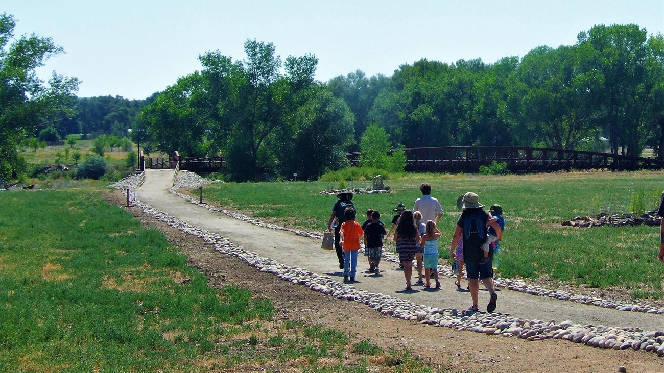 A group walking toward the Animas River.