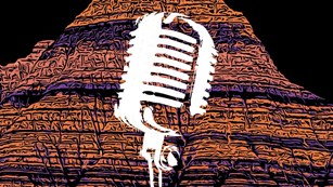stylized multicolor Badlands formations with a superimposed image of a white microphone.