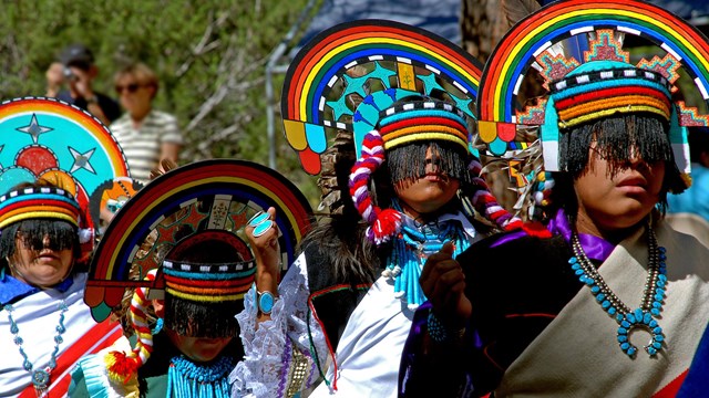 Native American dancers dressed in colorful traditional dancewear