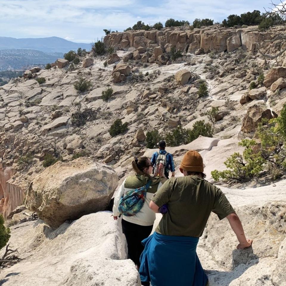 A group of people hiking along a rugged trail.