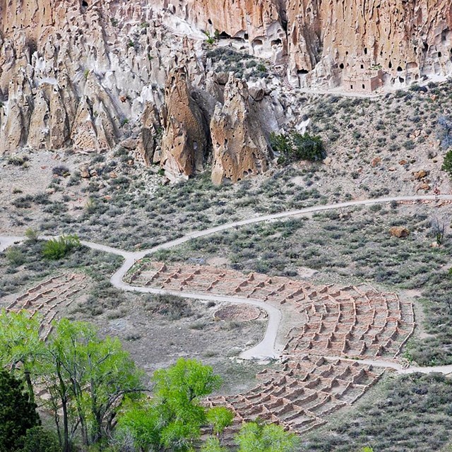 An aerial view of the remains of a circular Ancestral Pueblo village. 