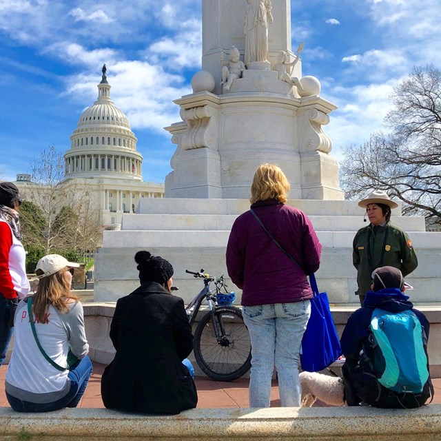 A park ranger speaks with a group near the U.S. Capitol