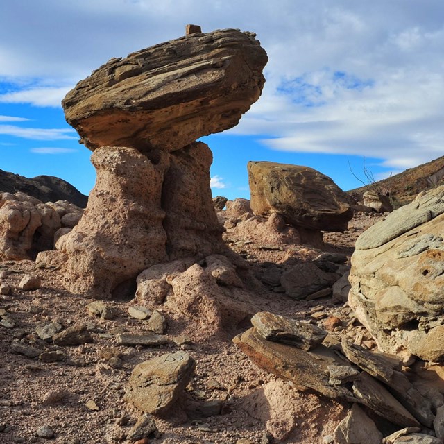 Sandstone blocks balance on narrow columns of rock.