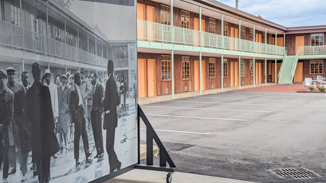 A historic display of civil rights activists is shown in front of a brick two story motel.