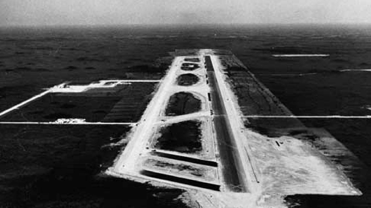 a man stands over blueprints for the jetport